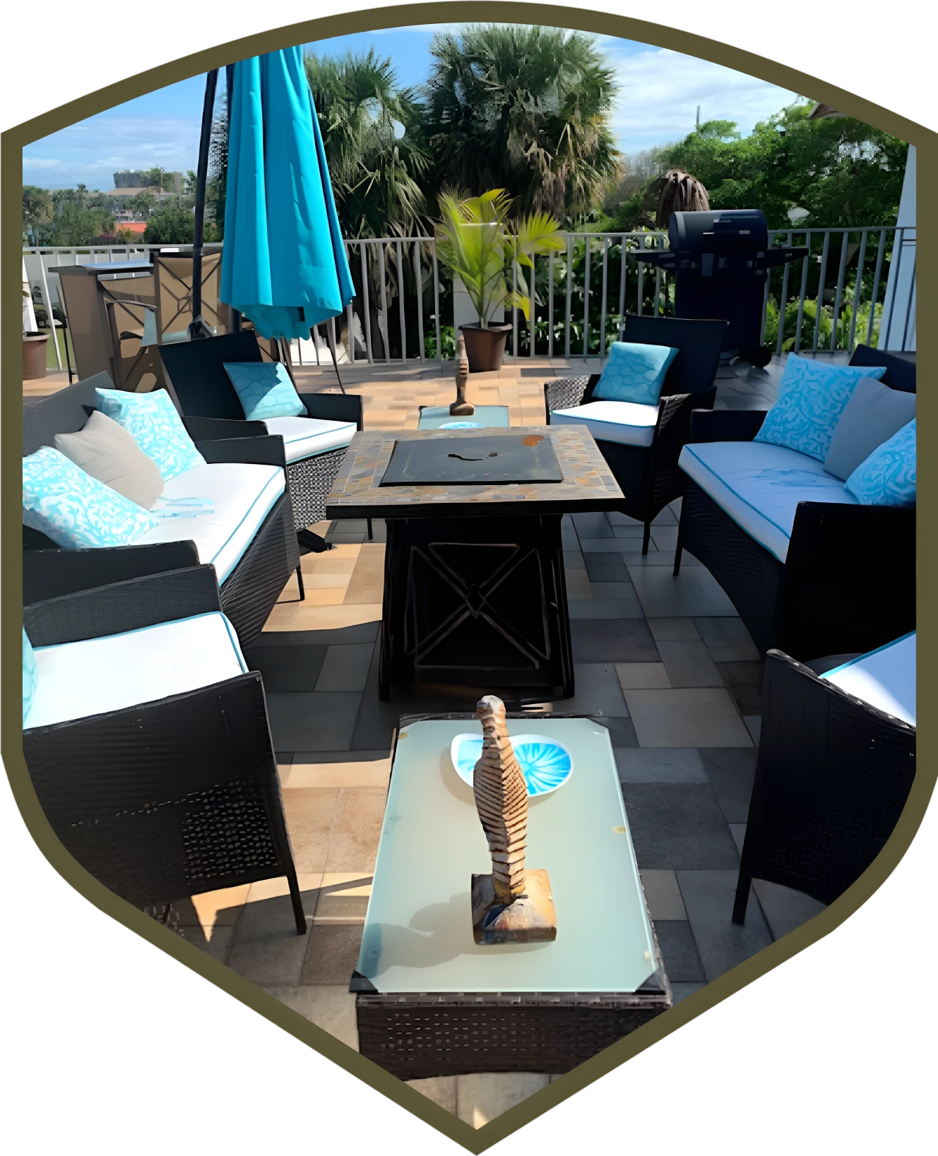 A patio with blue furniture and an umbrella.